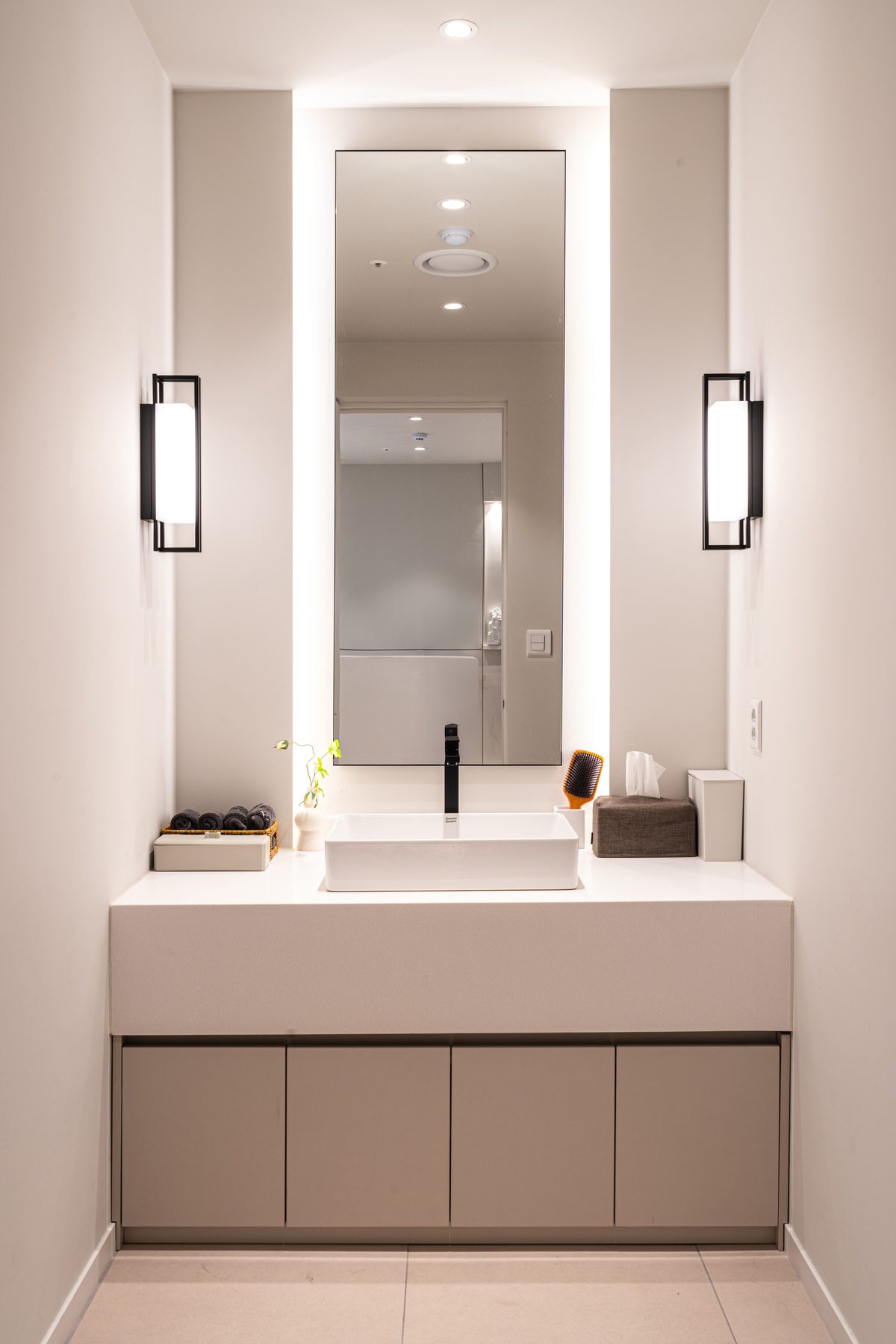 Powder room with a single vanity mirror and sink